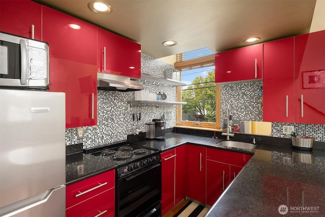 842 Washington St Unit 204, Port Townsend, WA 98368 - kitchen with red cabinets, appliances with stainless steel finishes, exhaust hood, and recessed lighting