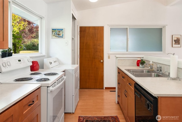 9922 SW 206th Ct, Vashon, WA 98070 - kitchen featuring white electric range oven, black dishwasher, washer / clothes dryer, light wood-style floors, and light countertops