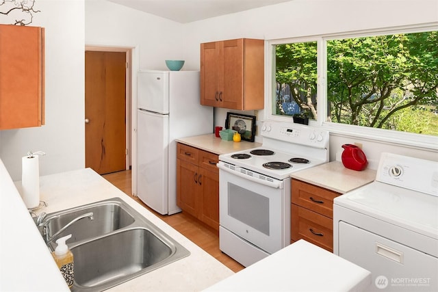9922 SW 206th Ct, Vashon, WA 98070 - kitchen with washer / clothes dryer, white appliances, brown cabinets, and light countertops