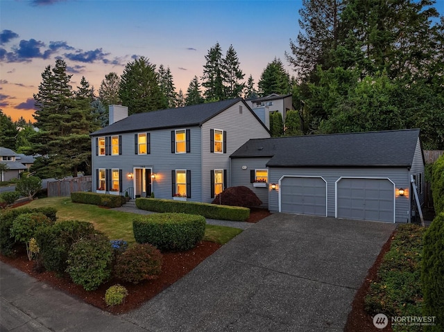 12810 SE 22nd Pl, Bellevue, WA 98005 - colonial-style house with a chimney, an attached garage, and driveway