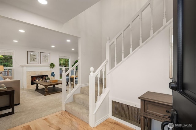 12810 SE 22nd Pl, Bellevue, WA 98005 - staircase with wood finished floors, recessed lighting, and a tiled fireplace