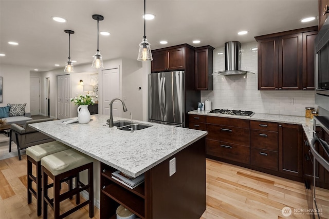 12810 SE 22nd Pl, Bellevue, WA 98005 - kitchen with appliances with stainless steel finishes, wall chimney range hood, light wood-type flooring, tasteful backsplash, and light stone countertops