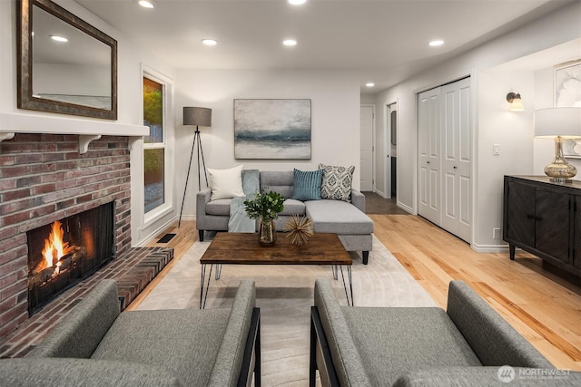 12810 SE 22nd Pl, Bellevue, WA 98005 - living area with light wood finished floors, a fireplace, and recessed lighting