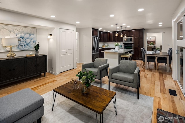 12810 SE 22nd Pl, Bellevue, WA 98005 - living room featuring light wood-style floors and recessed lighting