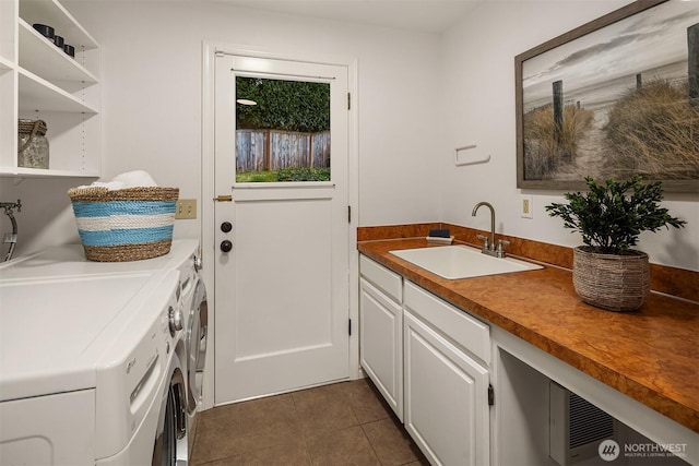 12810 SE 22nd Pl, Bellevue, WA 98005 - washroom featuring washing machine and clothes dryer, cabinet space, and dark tile patterned floors