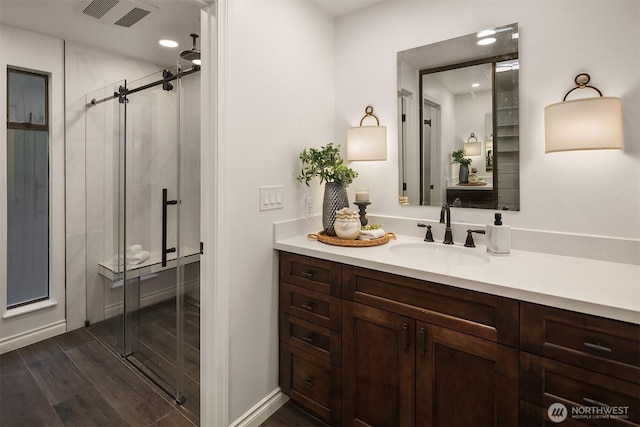 12810 SE 22nd Pl, Bellevue, WA 98005 - bathroom with vanity, a stall shower, wood finished floors, and recessed lighting