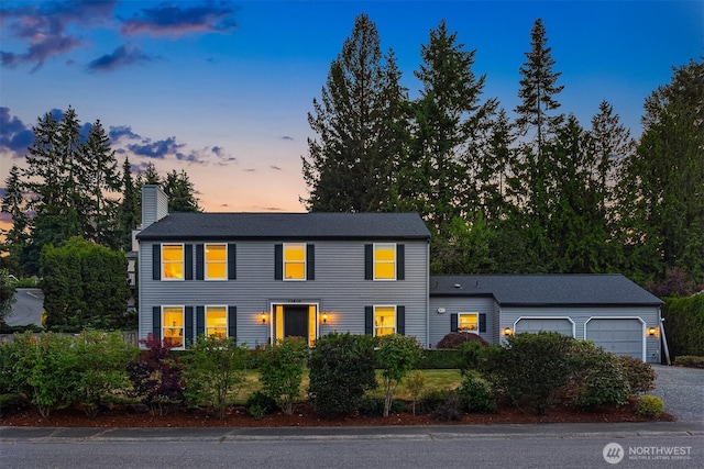 12810 SE 22nd Pl, Bellevue, WA 98005 - colonial house featuring a chimney, a garage, and driveway