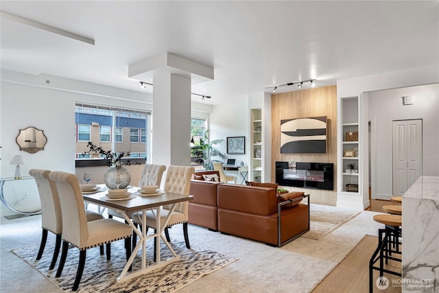 7800 SE 27th St Unit 302, Mercer Island, WA 98040 - dining space featuring track lighting, built in shelves, and a fireplace