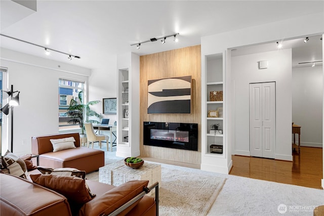 7800 SE 27th St Unit 302, Mercer Island, WA 98040 - living room with rail lighting, built in shelves, and a fireplace