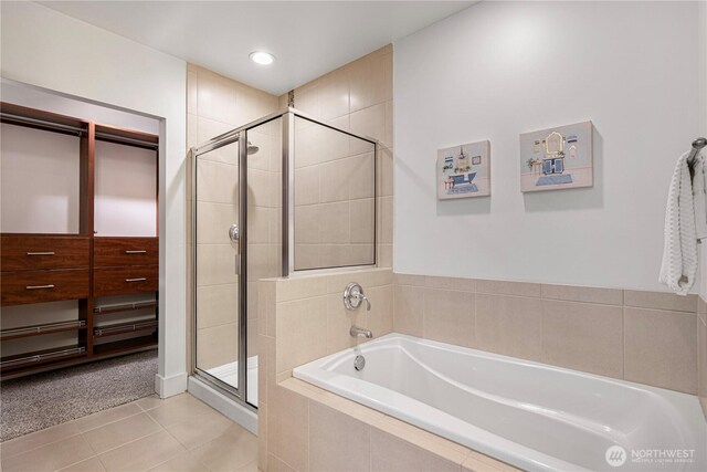 7800 SE 27th St Unit 302, Mercer Island, WA 98040 - full bathroom featuring a bath, a shower stall, and tile patterned floors