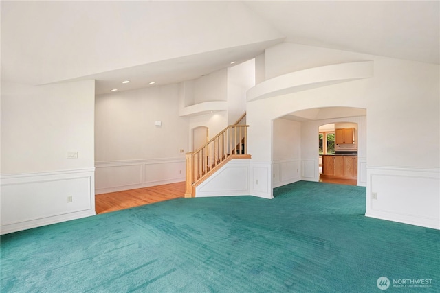 2804 18th St SE, Puyallup, WA 98374 - spare room with arched walkways, stairs, a wainscoted wall, high vaulted ceiling, and recessed lighting