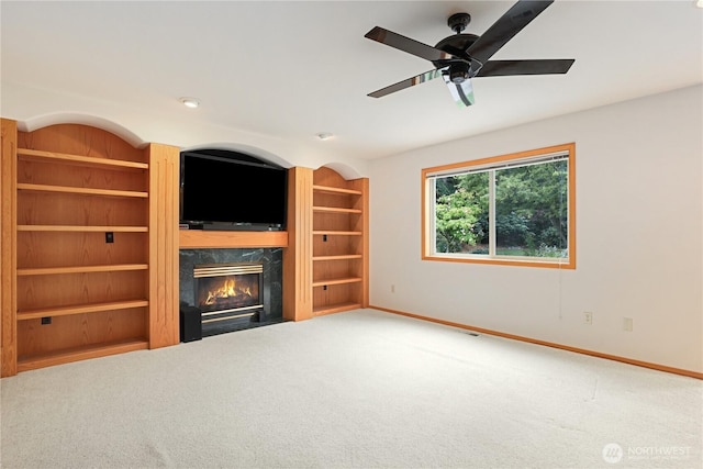 2804 18th St SE, Puyallup, WA 98374 - unfurnished living room with carpet flooring, a high end fireplace, a ceiling fan, and built in shelves