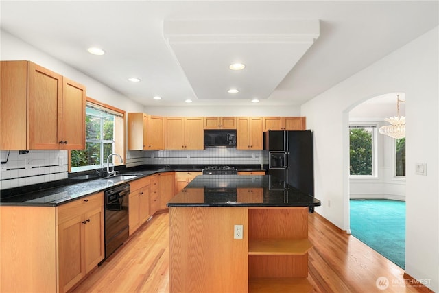 2804 18th St SE, Puyallup, WA 98374 - kitchen featuring black appliances, a center island, light wood finished floors, open shelves, and tasteful backsplash