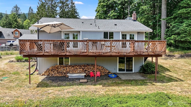 6511 Canyon Ct SW, Olympia, WA 98512 - back of property featuring a deck, a lawn, and a shingled roof