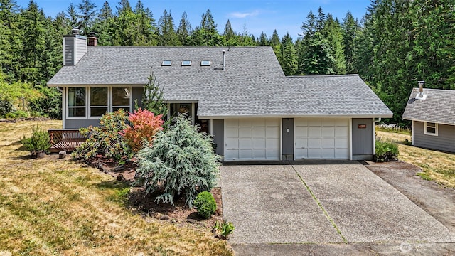 6511 Canyon Ct SW, Olympia, WA 98512 - view of front of home with a shingled roof, a chimney, and a garage