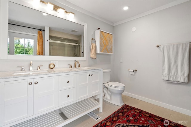 6511 Canyon Ct SW, Olympia, WA 98512 - bathroom featuring a shower with shower door, double vanity, and ornamental molding