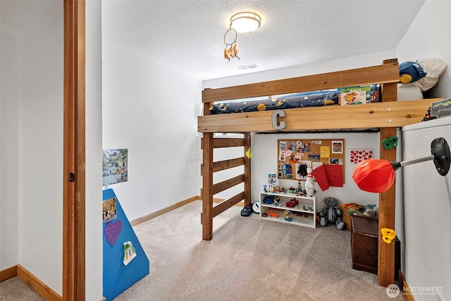 6511 Canyon Ct SW, Olympia, WA 98512 - carpeted bedroom with baseboards and a textured ceiling