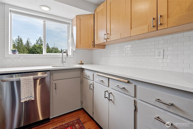 6511 Canyon Ct SW, Olympia, WA 98512 - kitchen with stainless steel dishwasher, light countertops, dark wood-type flooring, tasteful backsplash, and gray cabinets