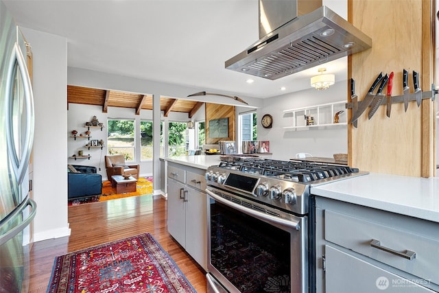 6511 Canyon Ct SW, Olympia, WA 98512 - kitchen featuring stainless steel appliances, wall chimney range hood, healthy amount of natural light, light wood-style floors, and recessed lighting