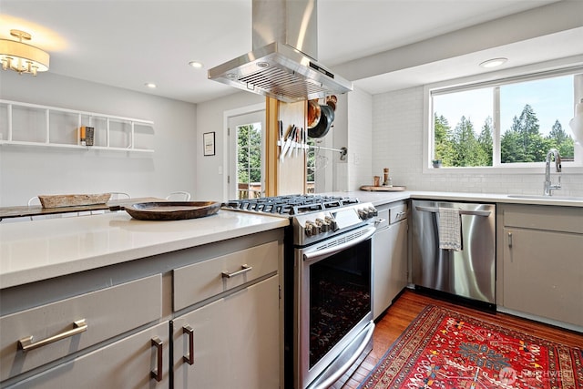 6511 Canyon Ct SW, Olympia, WA 98512 - kitchen with stainless steel appliances, island range hood, gray cabinetry, light countertops, and recessed lighting