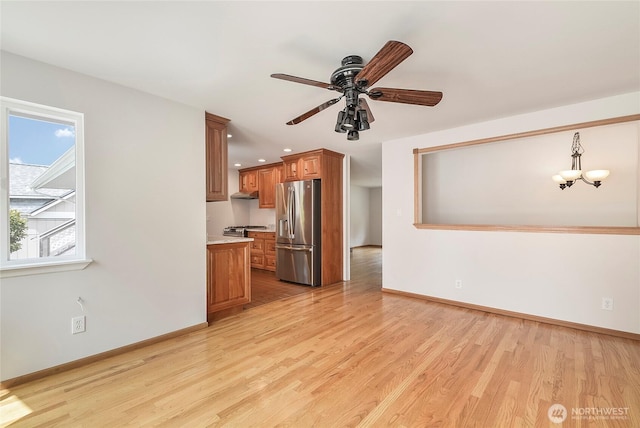 832 Birch St, Edmonds, WA 98020 - unfurnished living room with light wood finished floors, ceiling fan, recessed lighting, and a chandelier
