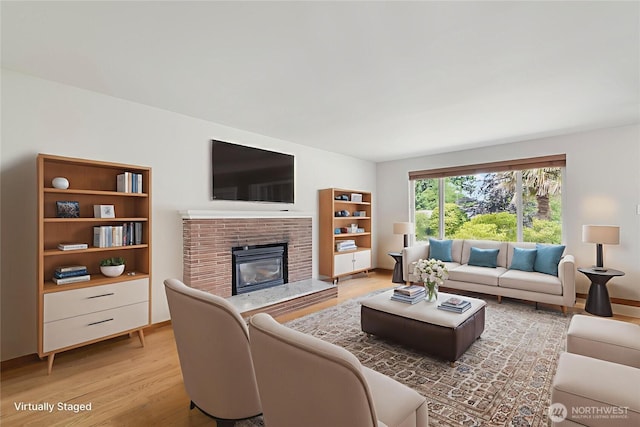 832 Birch St, Edmonds, WA 98020 - living area featuring a brick fireplace and light wood-type flooring