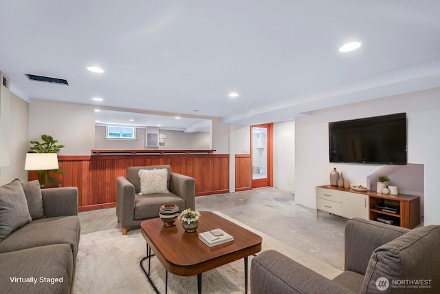 832 Birch St, Edmonds, WA 98020 - living area with unfinished concrete flooring, recessed lighting, and a wainscoted wall