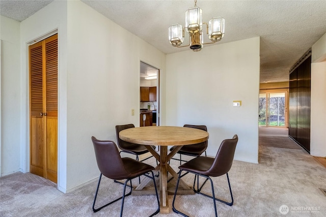 913 Woodlawn, Walla Walla, WA 99362 - dining room featuring light carpet, a chandelier, and a textured ceiling