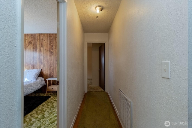 913 Woodlawn, Walla Walla, WA 99362 - hallway with a textured wall, carpet flooring, a textured ceiling, and wood walls