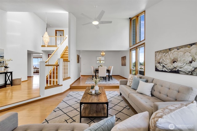 14007 65th Pl W, Edmonds, WA 98026 - living area with a towering ceiling, stairway, wood finished floors, healthy amount of natural light, and ceiling fan