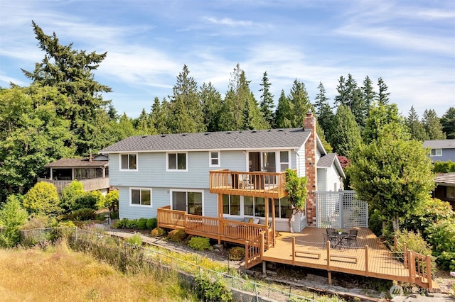 14007 65th Pl W, Edmonds, WA 98026 - back of house featuring a chimney, a deck, and view of wooded area