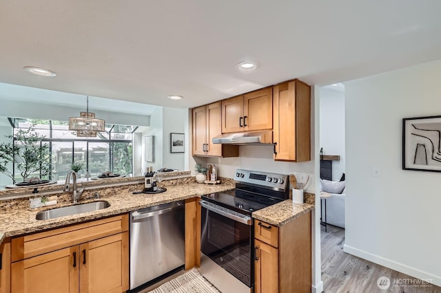 12200 100th Ave NE Unit N-D, Kirkland, WA 98034 - kitchen featuring appliances with stainless steel finishes, under cabinet range hood, light stone counters, light wood finished floors, and recessed lighting
