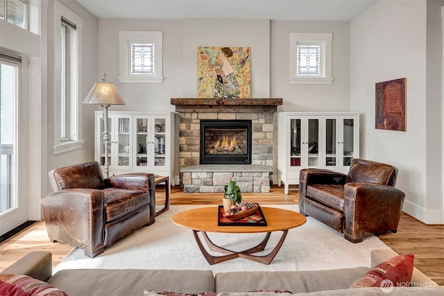 2611 9th Ave W, Seattle, WA 98119 - living room with healthy amount of natural light, wood finished floors, and a fireplace