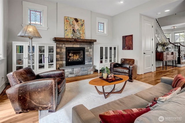 2611 9th Ave W, Seattle, WA 98119 - living room with wood finished floors, a fireplace, stairway, and recessed lighting