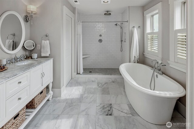 2611 9th Ave W, Seattle, WA 98119 - full bath featuring a tile shower, a freestanding bath, vanity, and marble look tile flooring