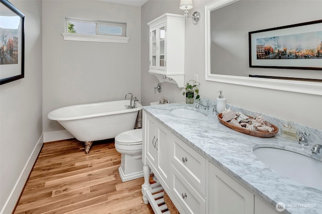 2611 9th Ave W, Seattle, WA 98119 - bathroom with double vanity, wood finished floors, and a soaking tub