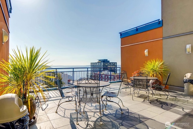 2414 1st Ave Unit 519, Seattle, WA 98121 - balcony featuring a water view and outdoor dining area