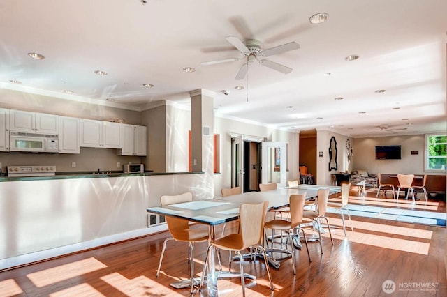 2414 1st Ave Unit 519, Seattle, WA 98121 - dining room featuring ceiling fan, light wood-type flooring, ornamental molding, and recessed lighting