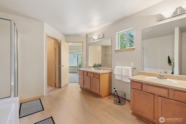 33036 42nd Ave S, Federal Way, WA 98001 - full bath with wood finished floors, a shower with shower door, two vanities, and a bathtub