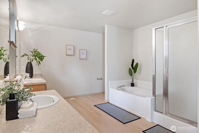 33036 42nd Ave S, Federal Way, WA 98001 - bathroom with wood finished floors, vanity, a garden tub, and a stall shower