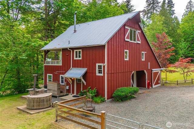 36 Seven Sisters Rd, Port Ludlow, WA 98365 - view of front of home with a barn, a detached garage, an outbuilding, and a metal roof