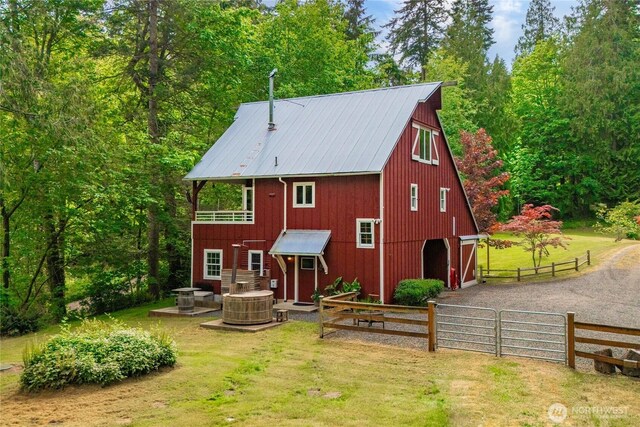 36 Seven Sisters Rd, Port Ludlow, WA 98365 - back of property with a barn, a detached garage, an outdoor structure, and a metal roof