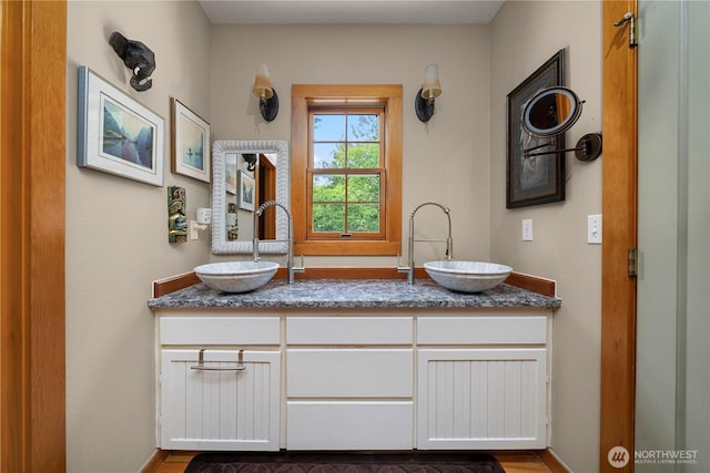 36 Seven Sisters Rd, Port Ludlow, WA 98365 - bathroom featuring double vanity and wood finished floors