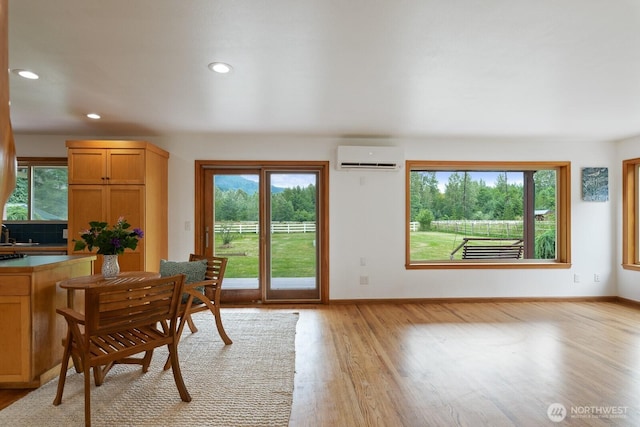 6373 Eastwood Rd, Deming, WA 98244 - dining space with light wood finished floors, a wall mounted AC, and recessed lighting