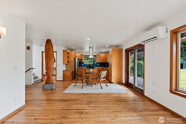 6373 Eastwood Rd, Deming, WA 98244 - dining room featuring a wall unit AC, plenty of natural light, light wood-style flooring, stairway, and recessed lighting