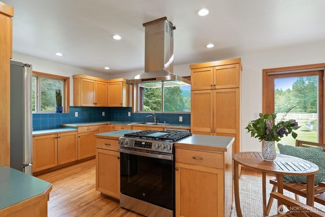 6373 Eastwood Rd, Deming, WA 98244 - kitchen with stainless steel appliances, island exhaust hood, light countertops, decorative backsplash, and healthy amount of natural light