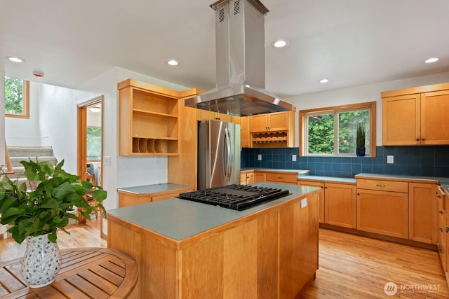 6373 Eastwood Rd, Deming, WA 98244 - kitchen with freestanding refrigerator, island range hood, cooktop, open shelves, and backsplash