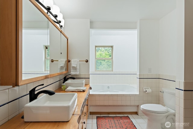 6373 Eastwood Rd, Deming, WA 98244 - full bath featuring a garden tub, vanity, tile walls, tile patterned flooring, and a wainscoted wall