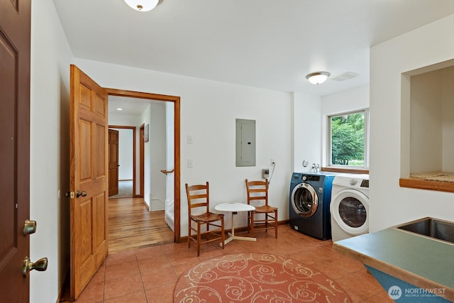 6373 Eastwood Rd, Deming, WA 98244 - laundry area featuring electric panel, washer and clothes dryer, and light tile patterned floors