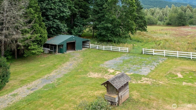 6373 Eastwood Rd, Deming, WA 98244 - view of yard with an outdoor structure, a pole building, a detached garage, and a view of trees